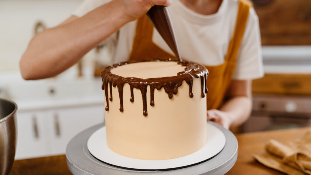 Making drip cake using piping bag